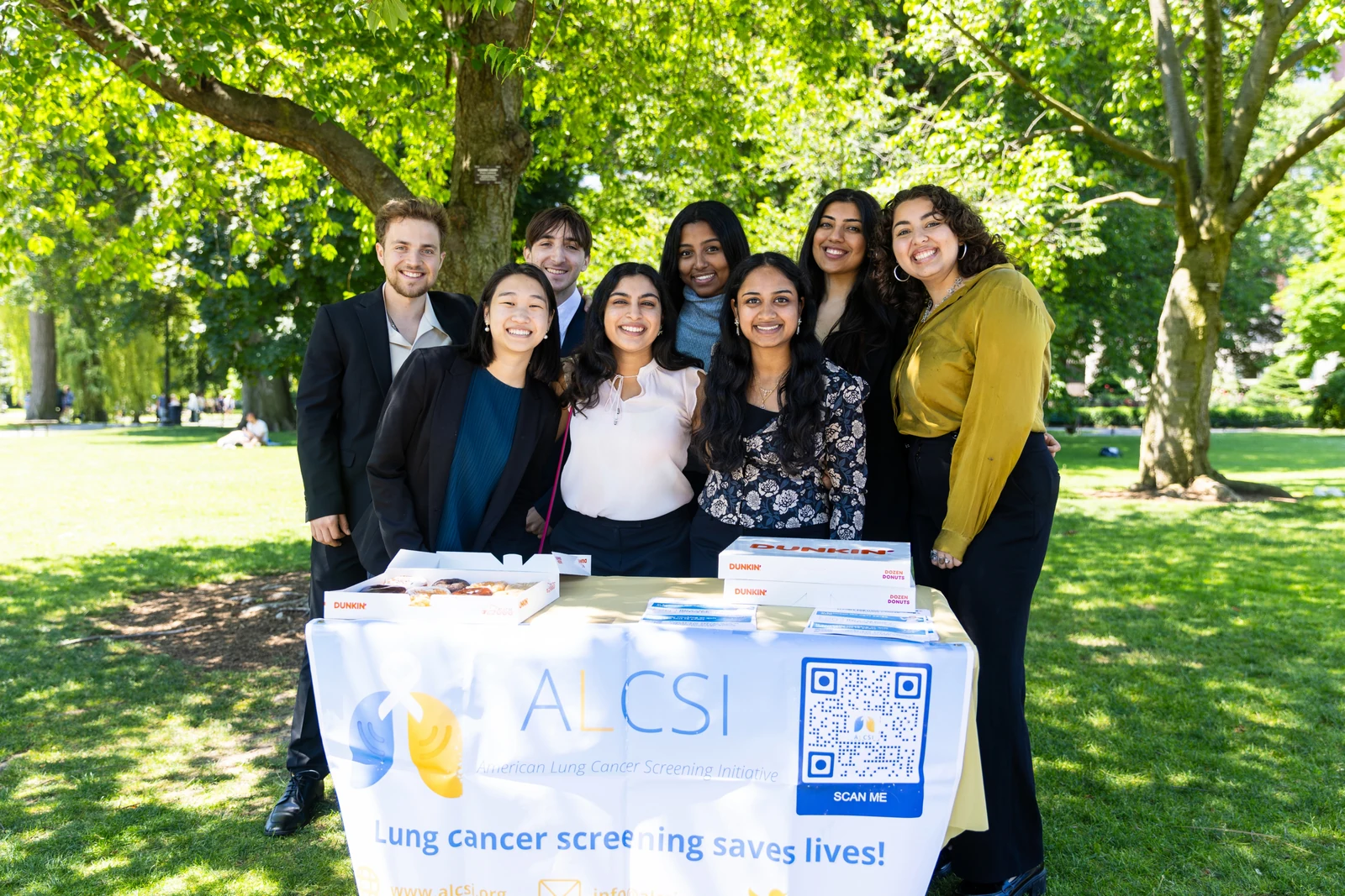 ALCSI volunteers sharing screening resources at an outdoor information table