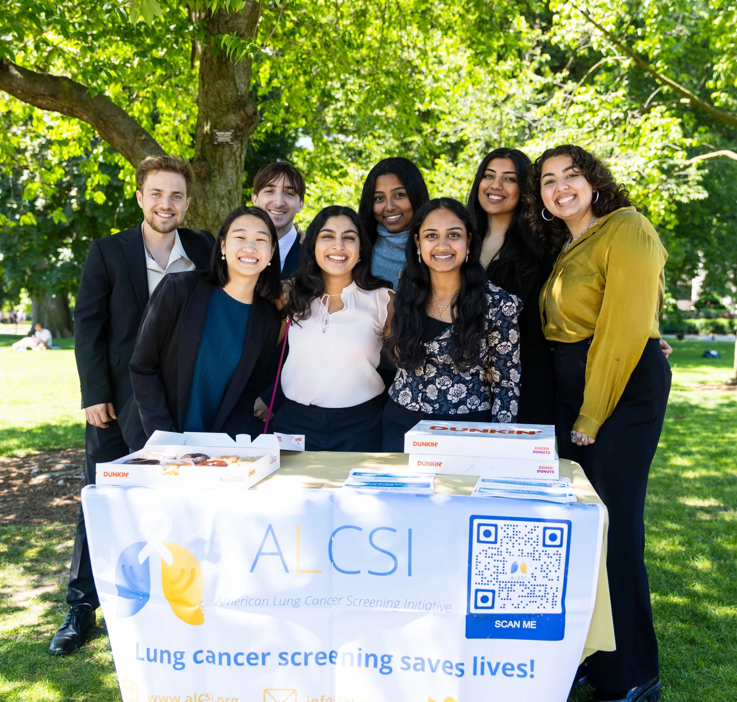 ALCSI volunteers sharing screening resources at an outdoor information table