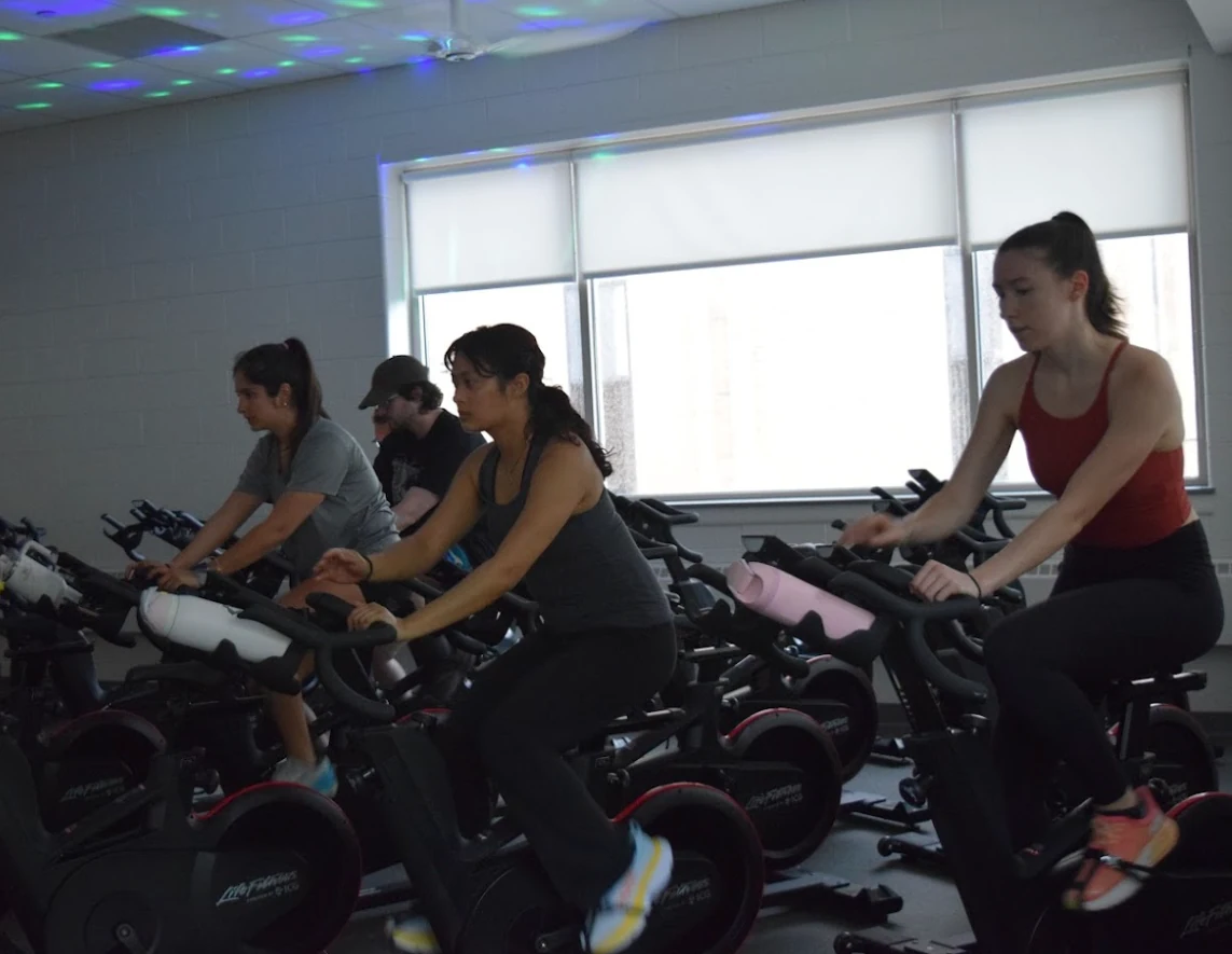 ALCSI participants taking part in an indoor cycling challenge with Ride Hard Breathe Easy