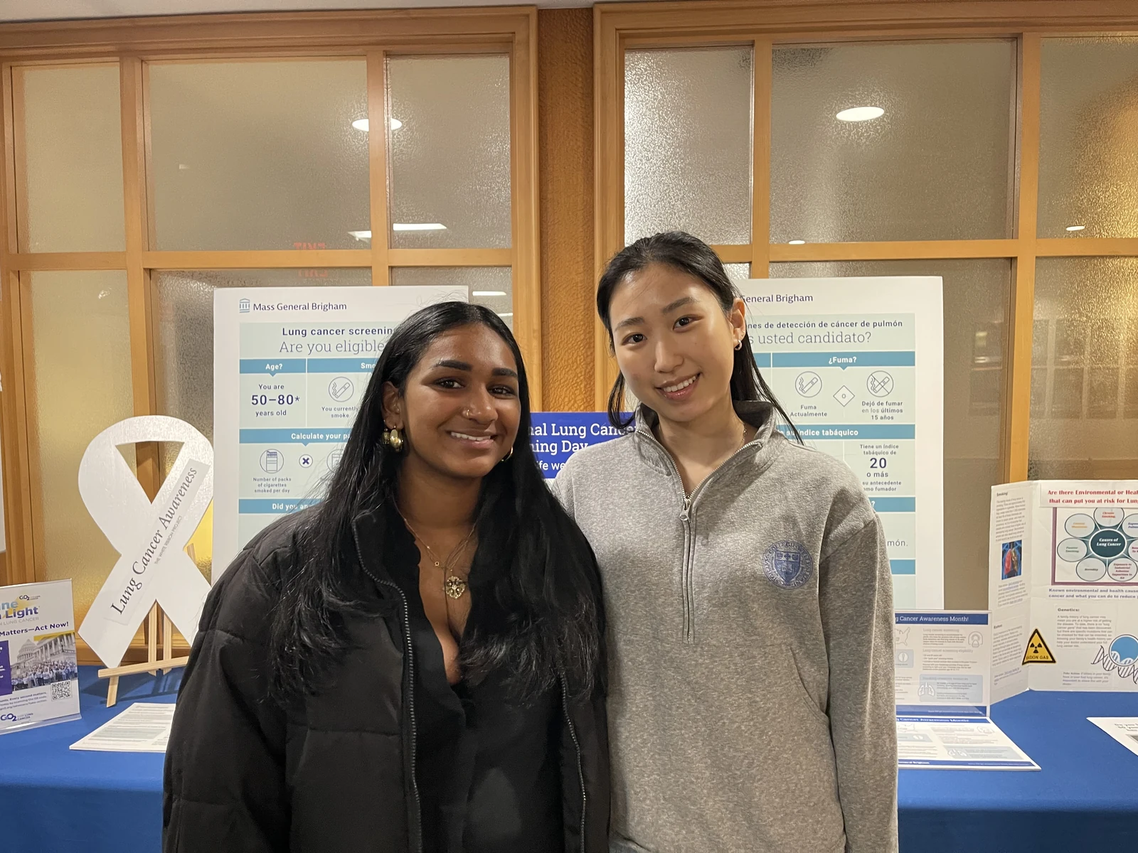 Two ALCSI volunteers with a white lung cancer awareness ribbon