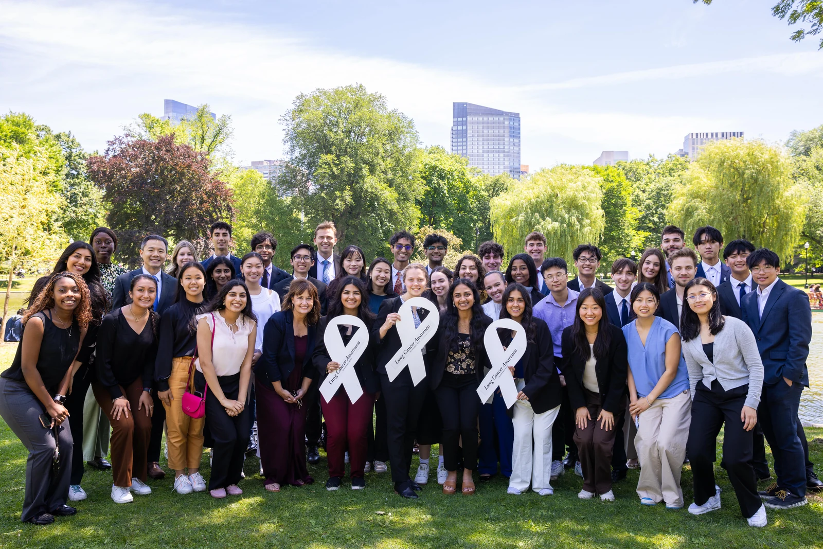 ALCSI advocates gathered outdoors with white lung cancer awareness ribbons