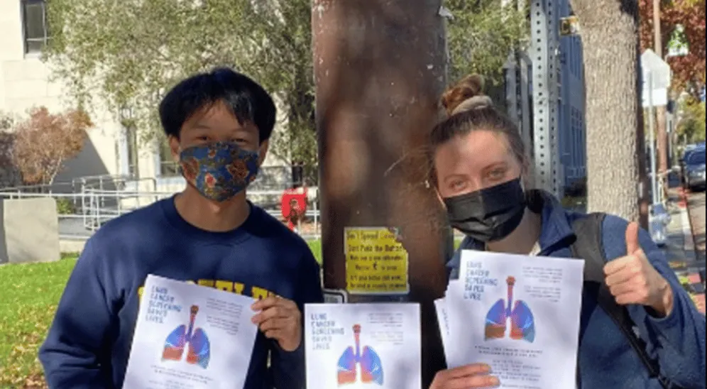 ALCSI volunteers holding lung cancer screening information outdoors