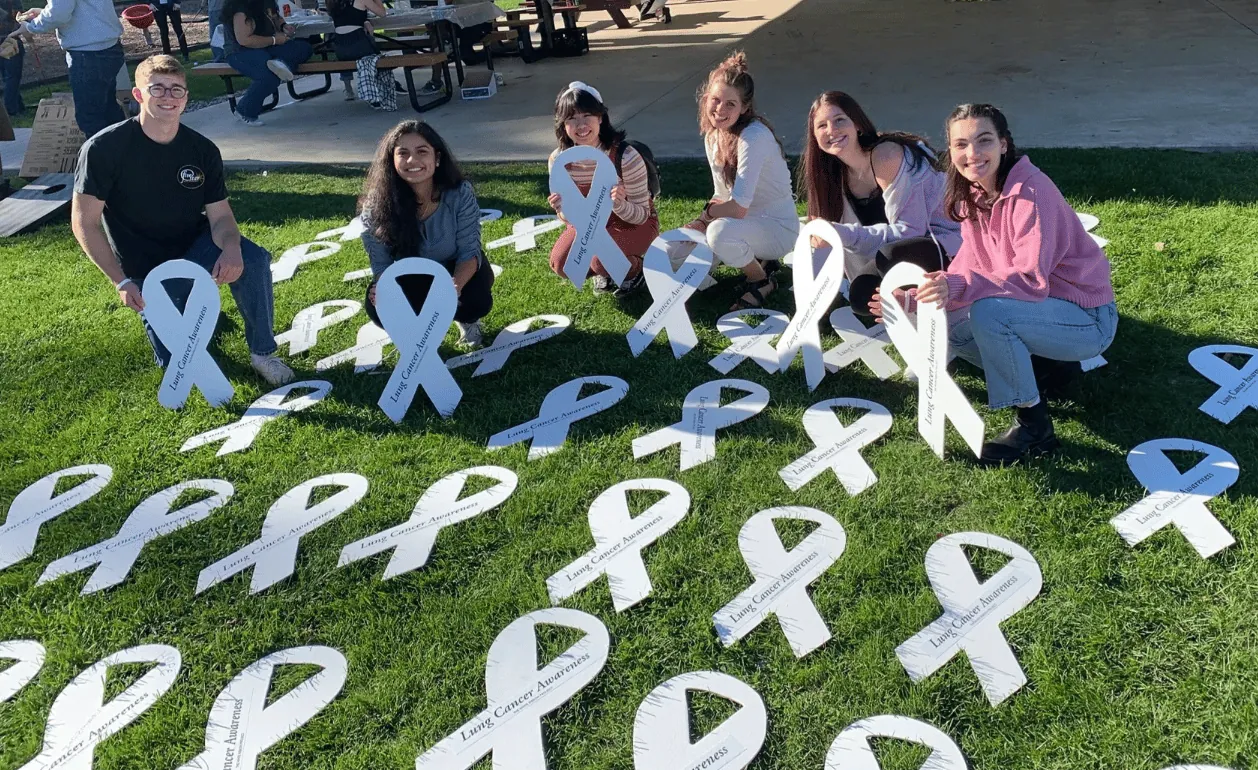 White lung cancer awareness ribbons arranged outdoors