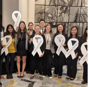 ALCSI members holding white lung cancer awareness ribbons