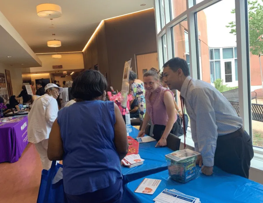 ALCSI members speaking with visitors at a health fair