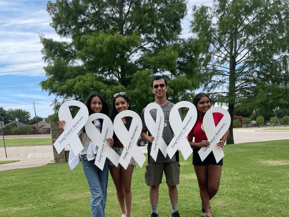 ALCSI members outdoors with white ribbons