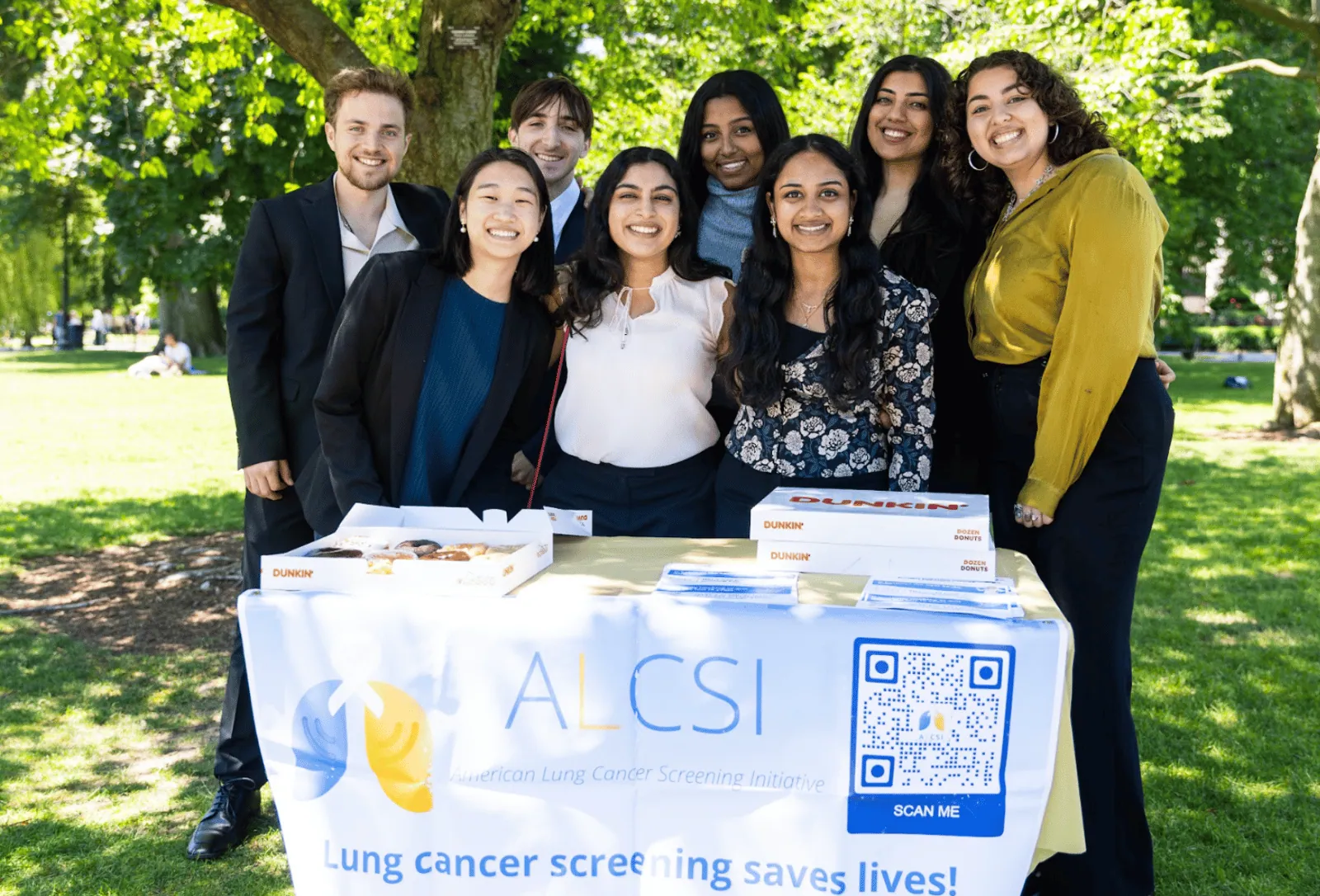 ALCSI volunteers welcoming visitors at a park outreach table