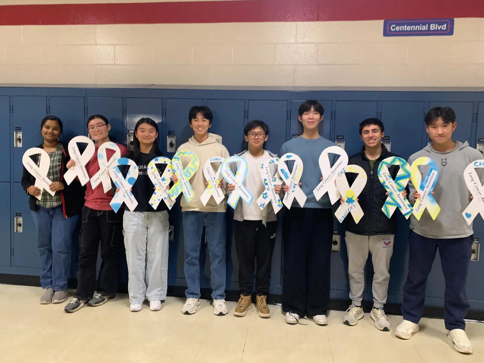 ALCSI members standing together with white ribbons