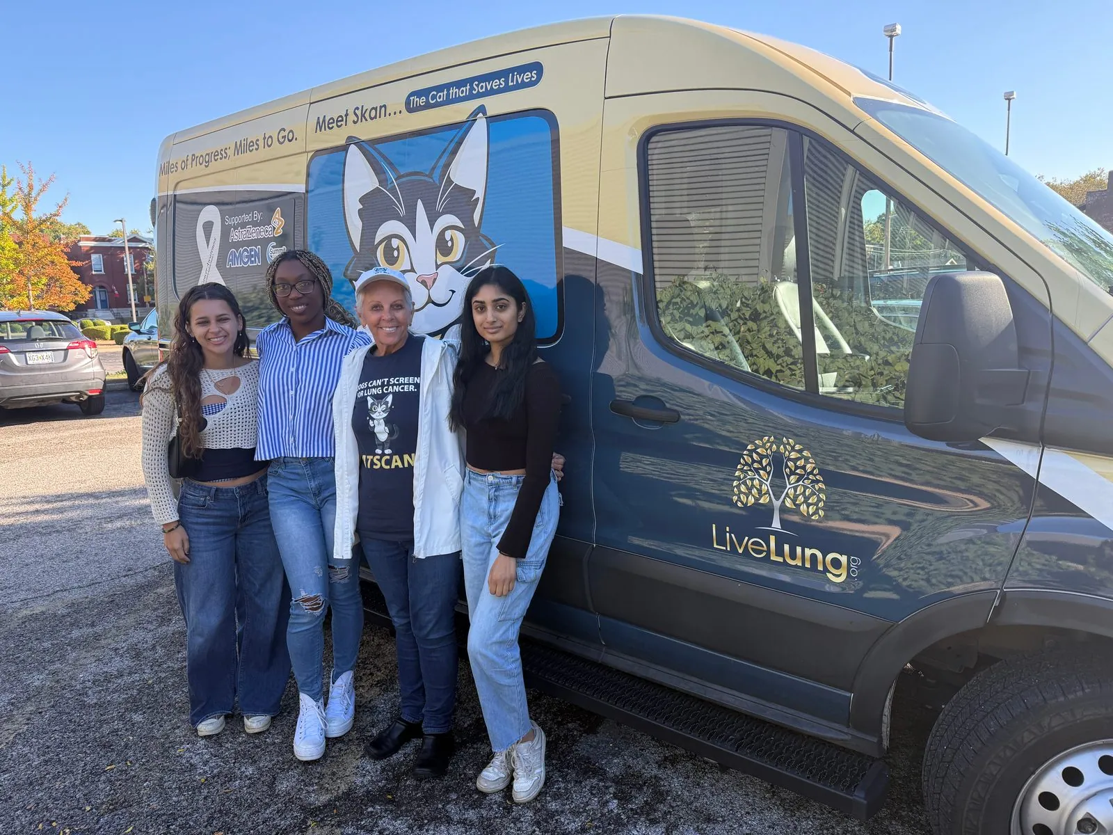 Volunteers standing beside the lung cancer screening outreach van