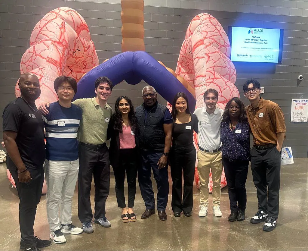 ALCSI members gathered in front of a lung health display