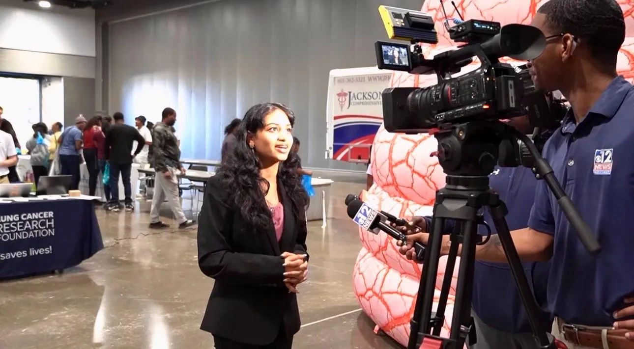 ALCSI representative speaking with a television reporter