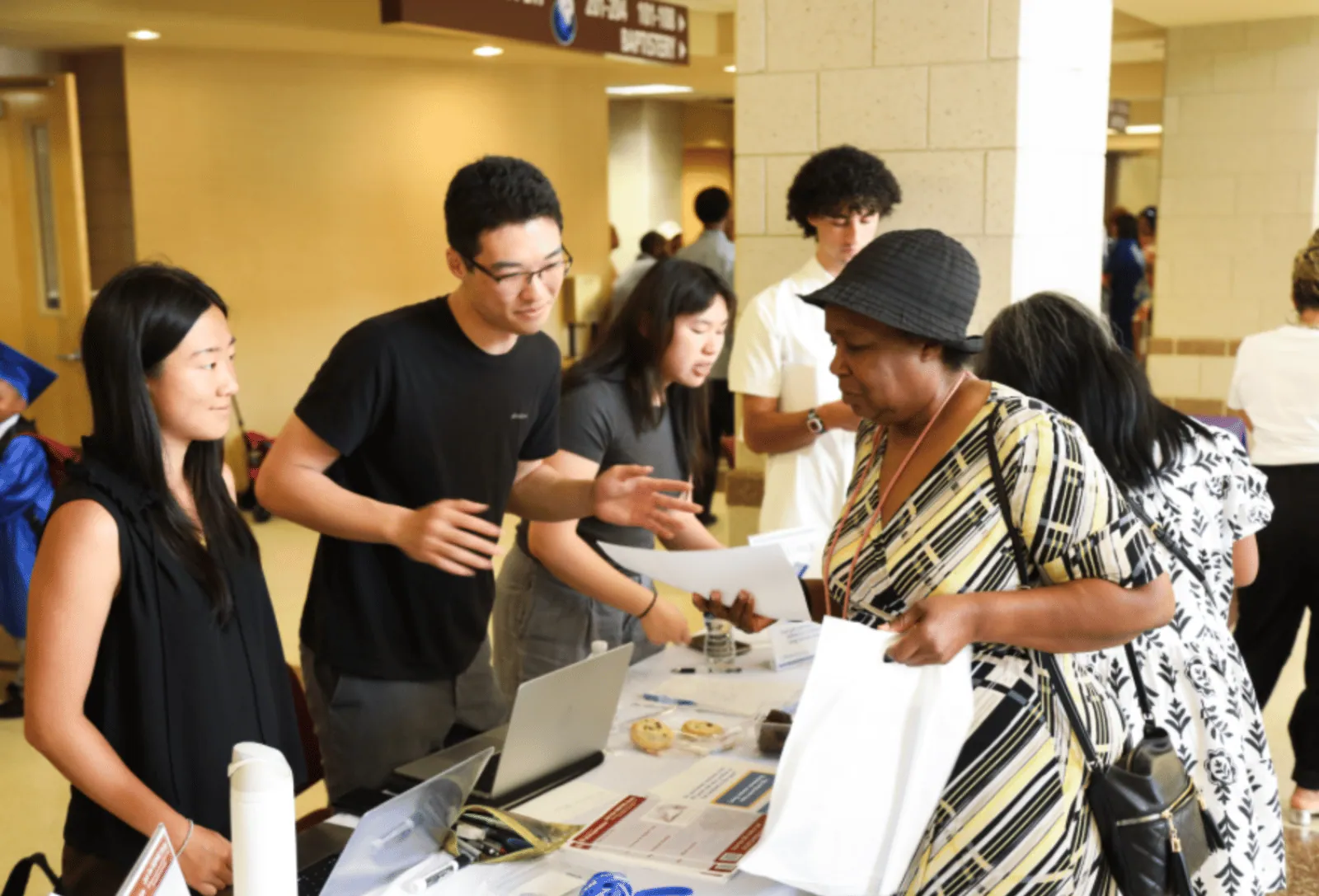Volunteer discussing screening information with a visitor