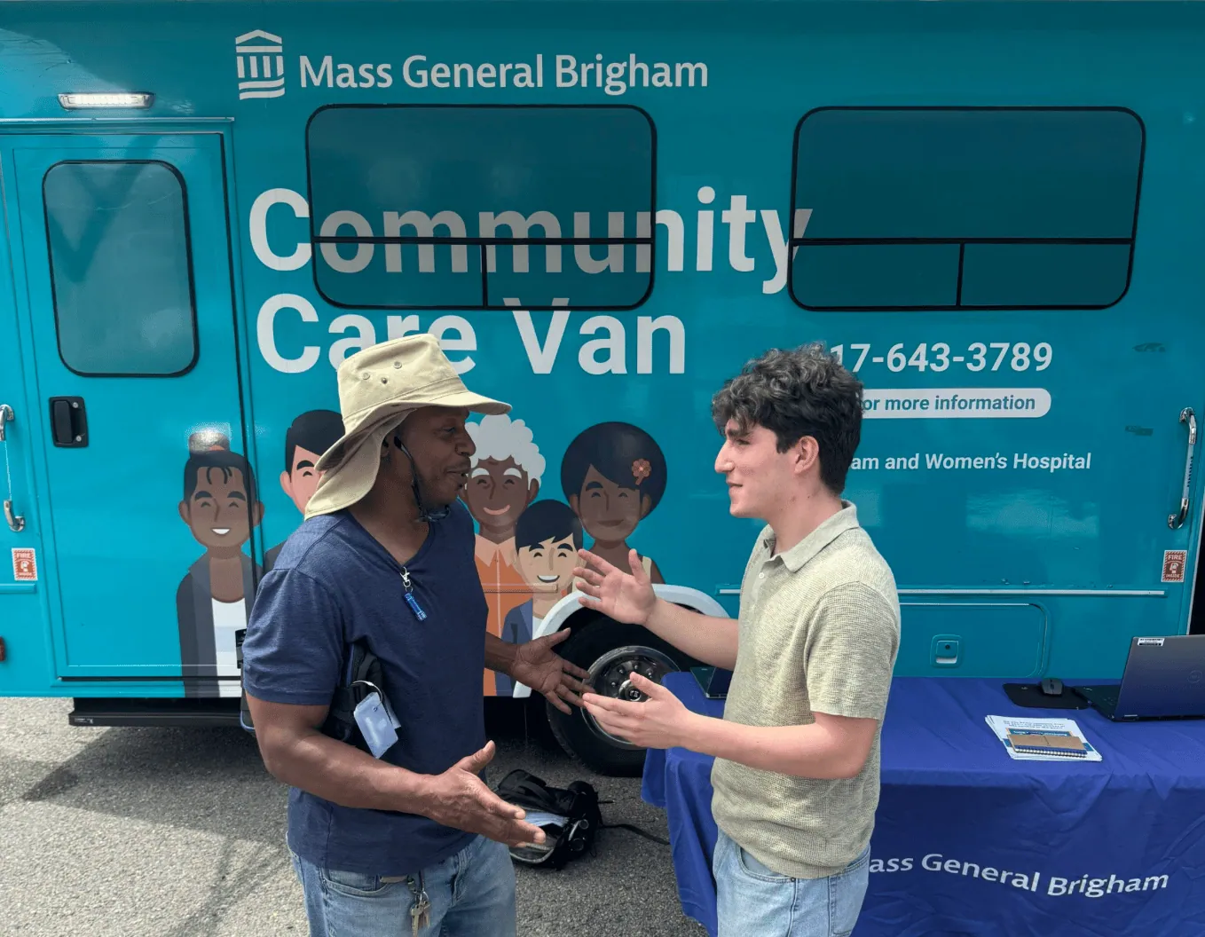 Volunteers beside the Mass General Brigham community care van