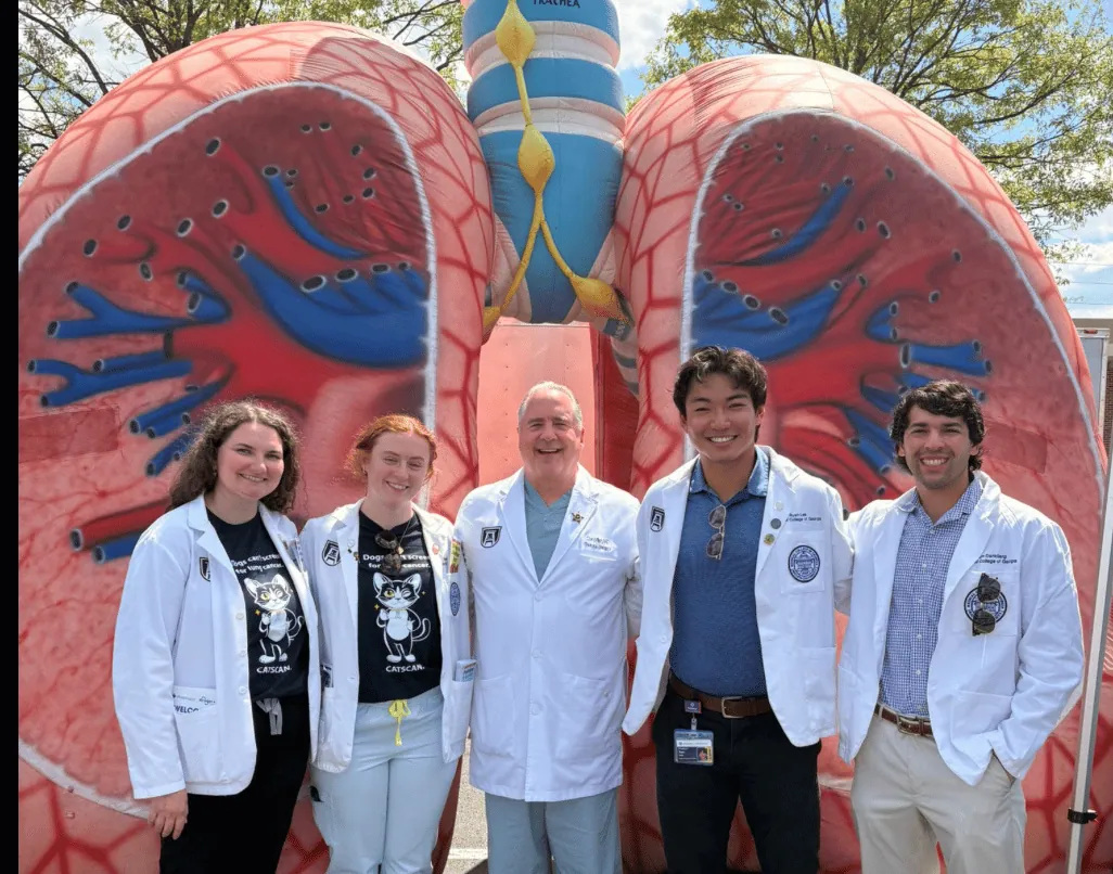 Advocates and clinicians gathered in front of a colorful lung mural