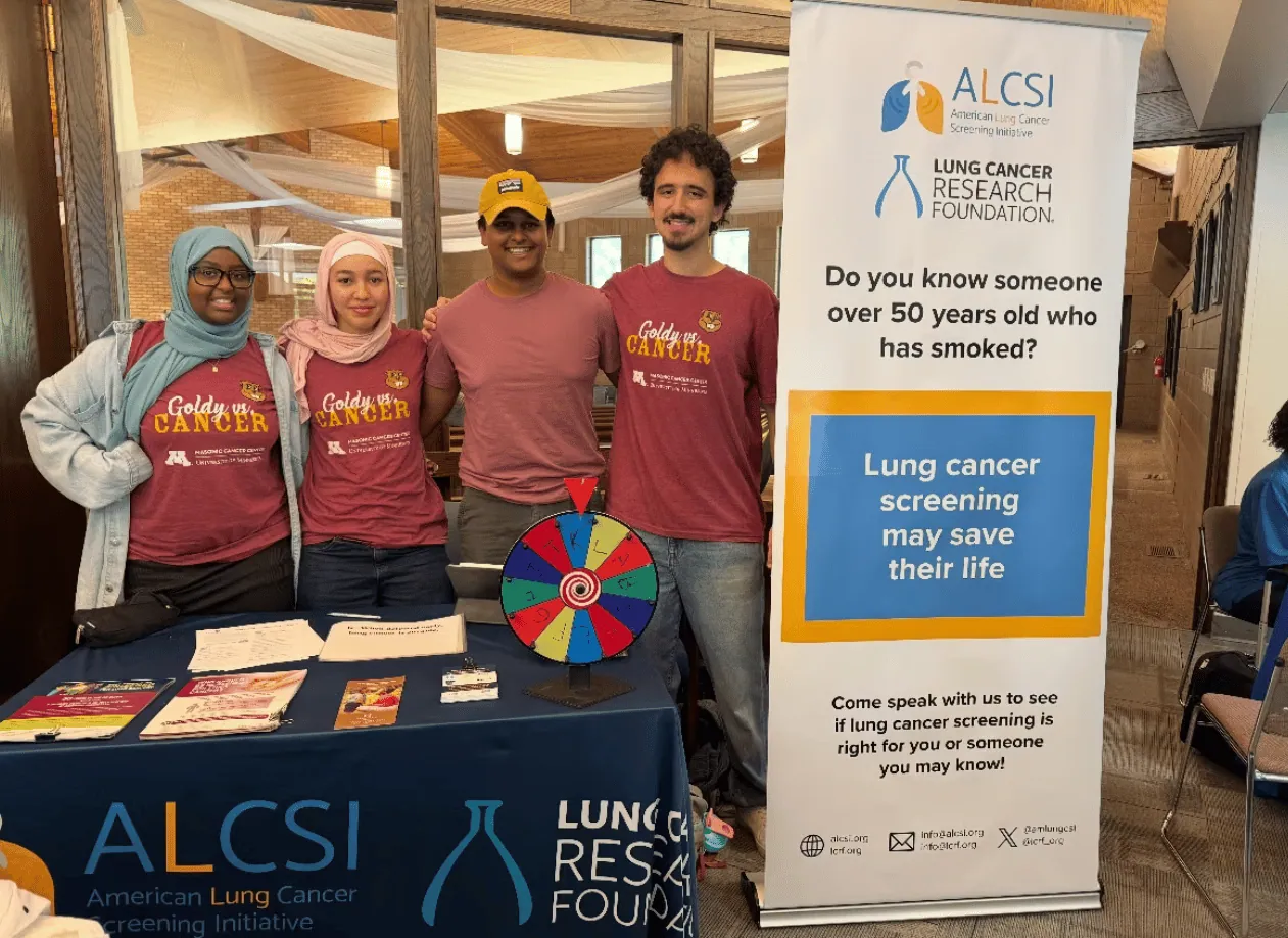 Community members and volunteers at an ALCSI information table