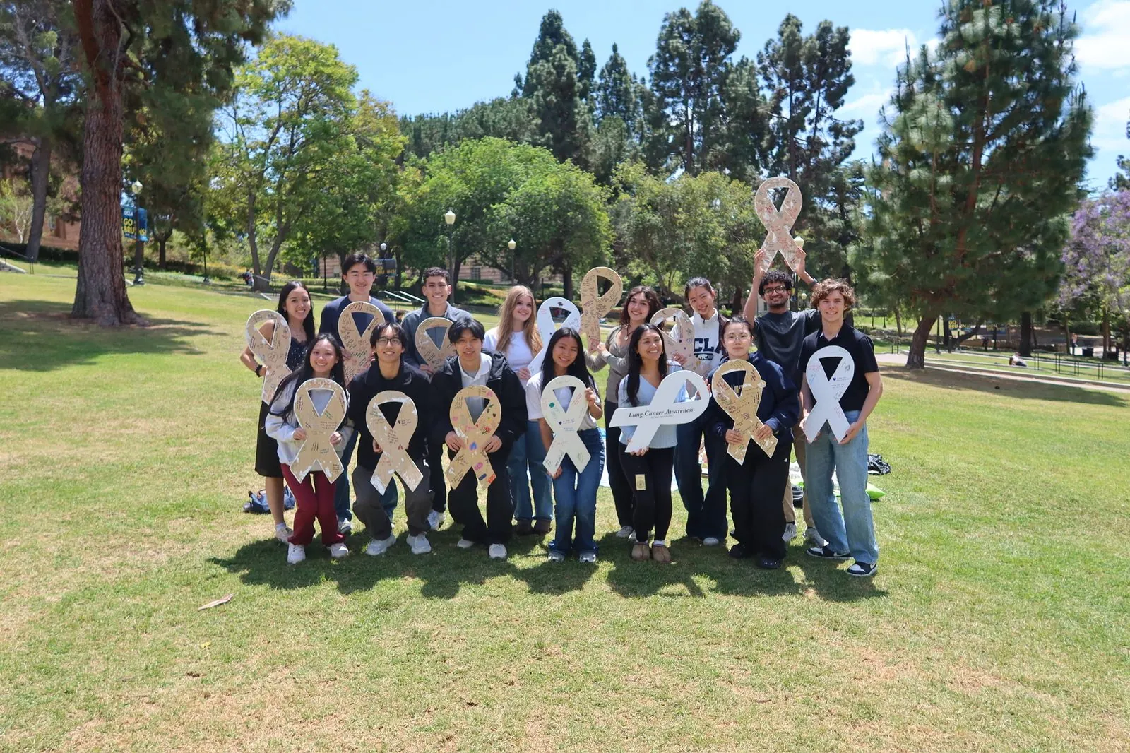 ALCSI volunteers gathered outdoors with white ribbons