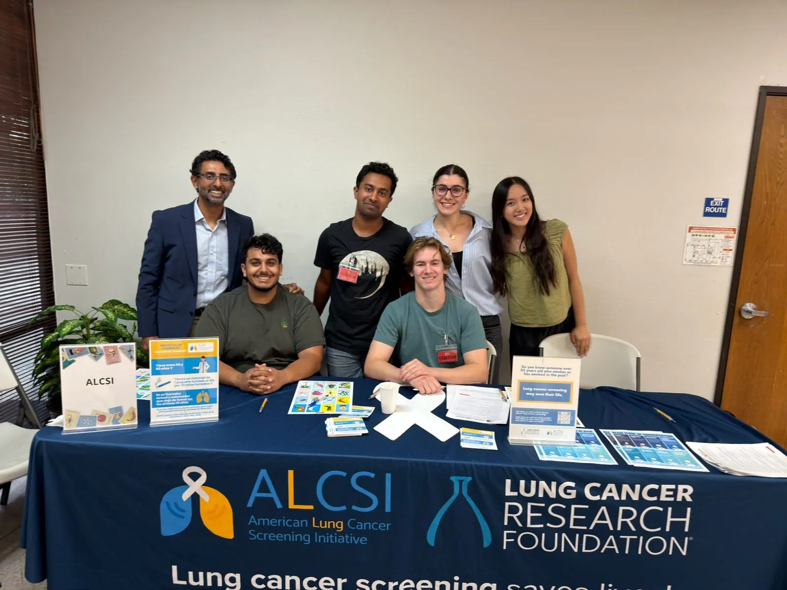 Volunteers sharing lung cancer screening materials at a community table
