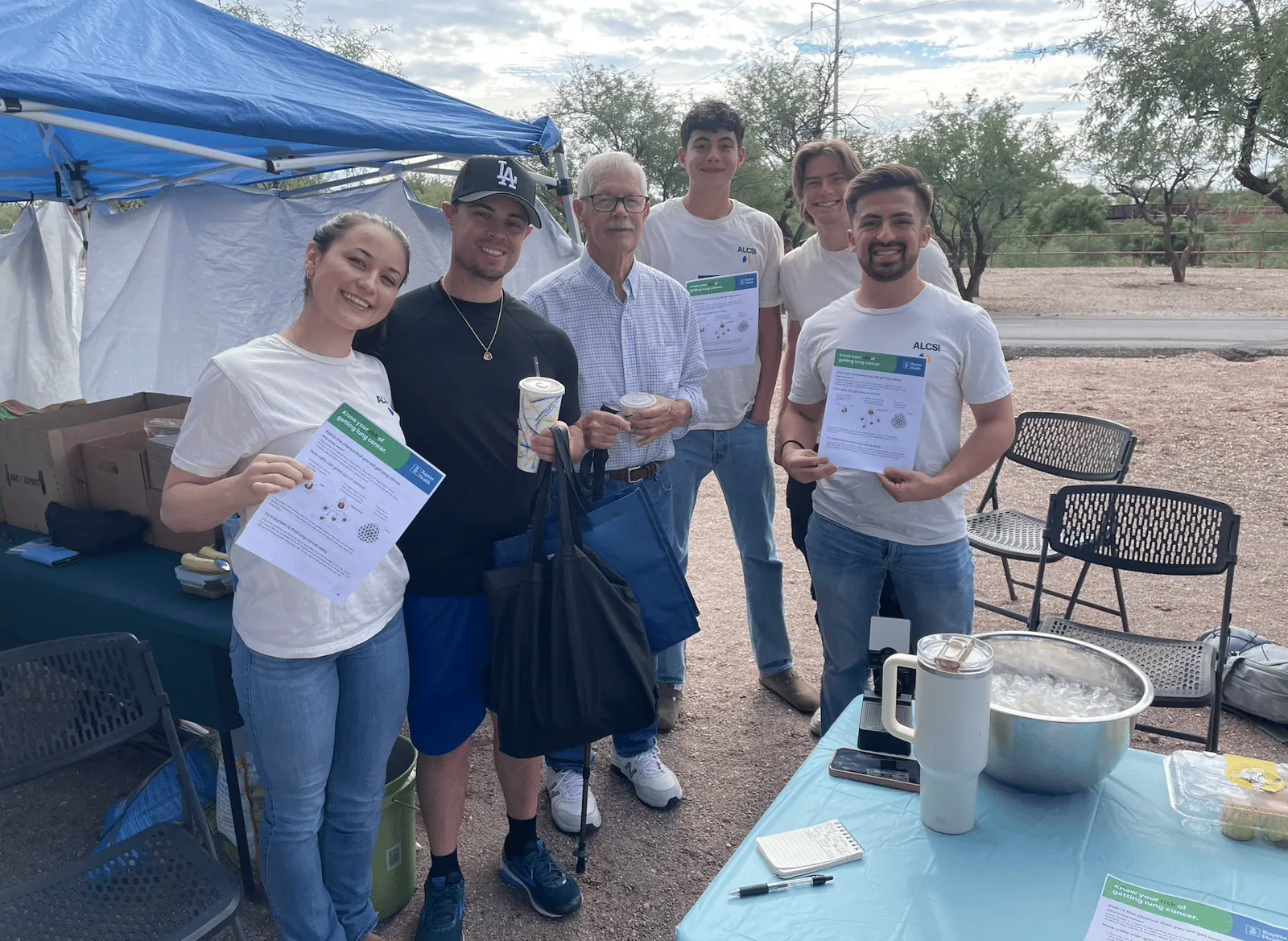 ALCSI volunteers talking with community members outdoors