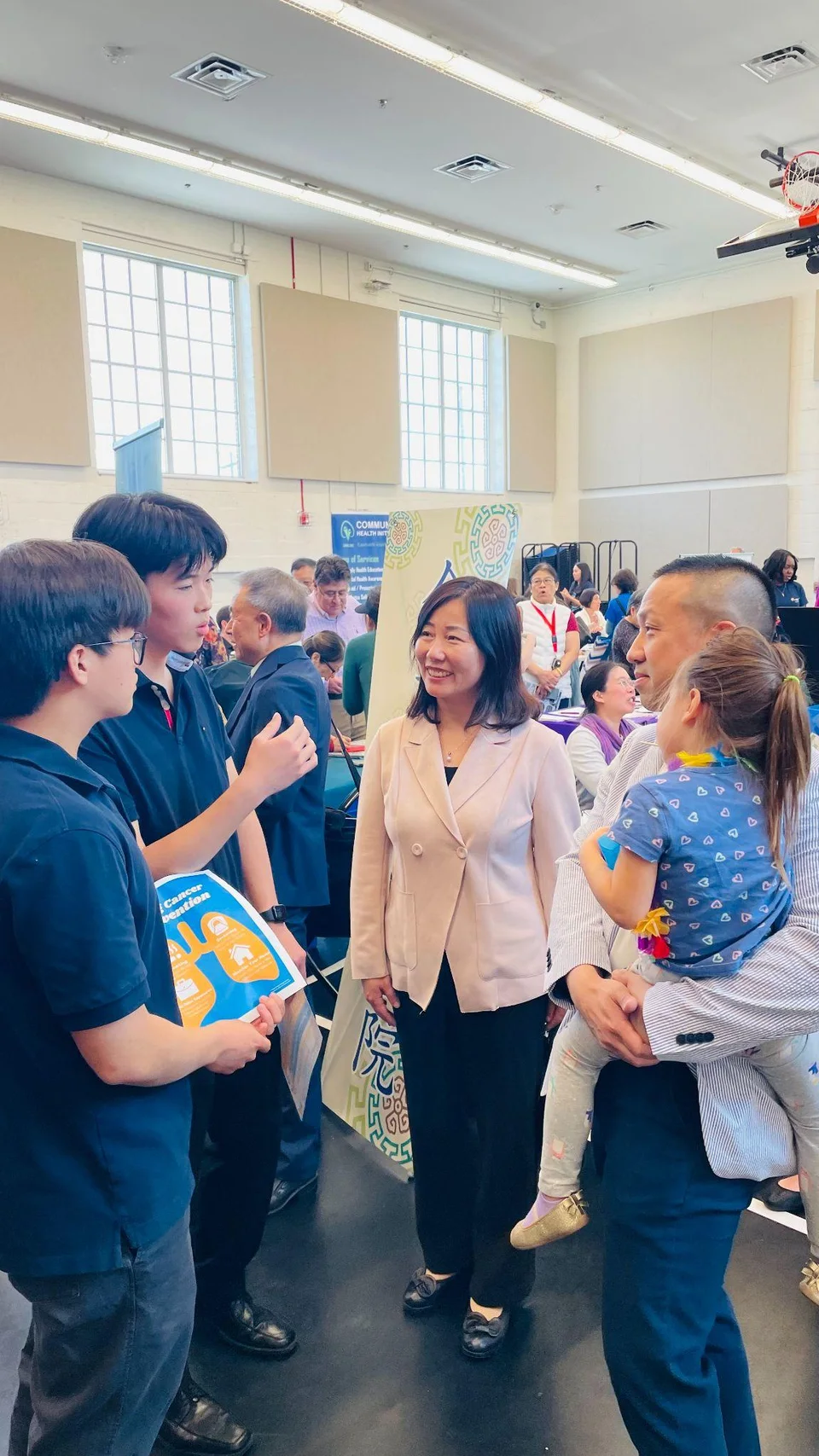 Students talking with attendees at a health fair