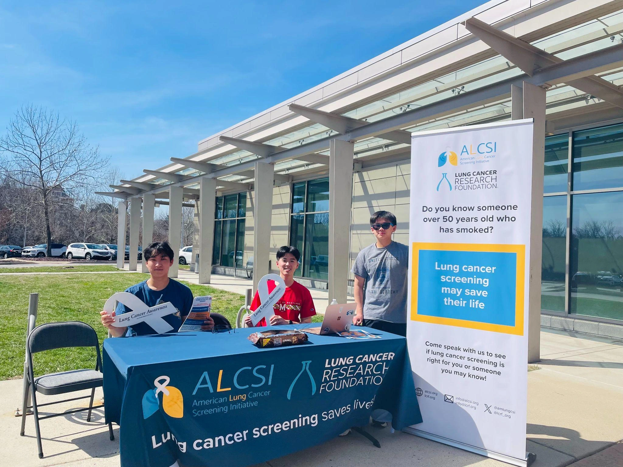 Centennial High School students at an ALCSI and Lung Cancer Research Foundation table outside Miller Branch Library