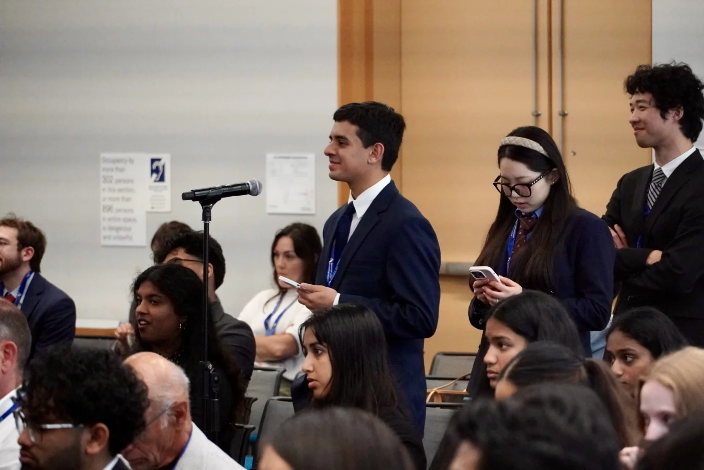 Students asking questions at a microphone during the Summit